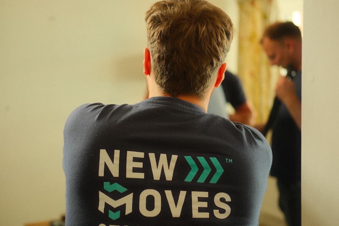 A New Moves Removals team member, seen from behind, wearing a branded New Moves top