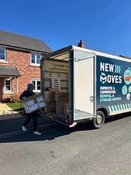 A New Moves Removals team member carrying a box from the removal van