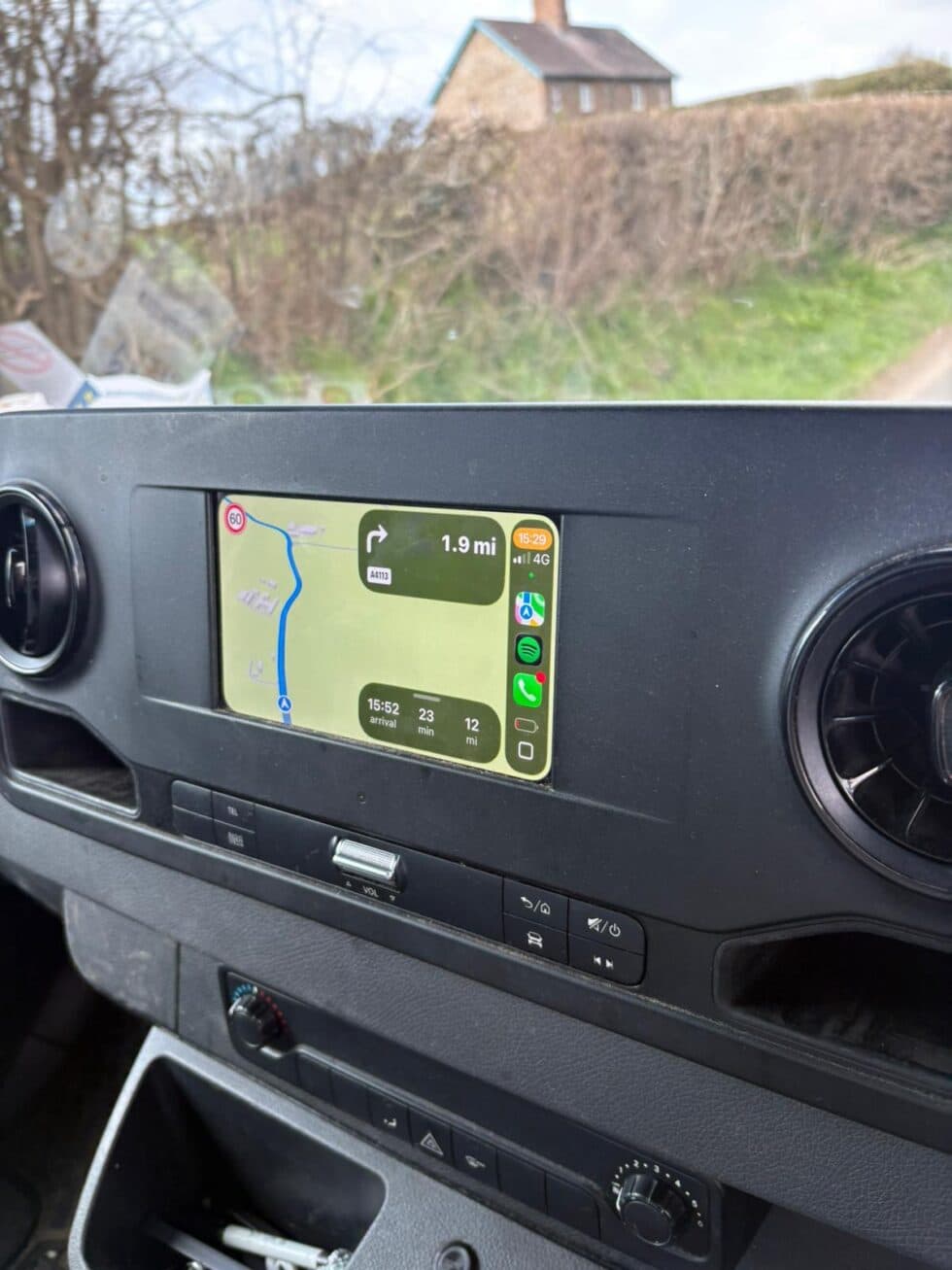 Sat nav screen on a van dashboard showing turn-by-turn directions while driving to a home removal survey