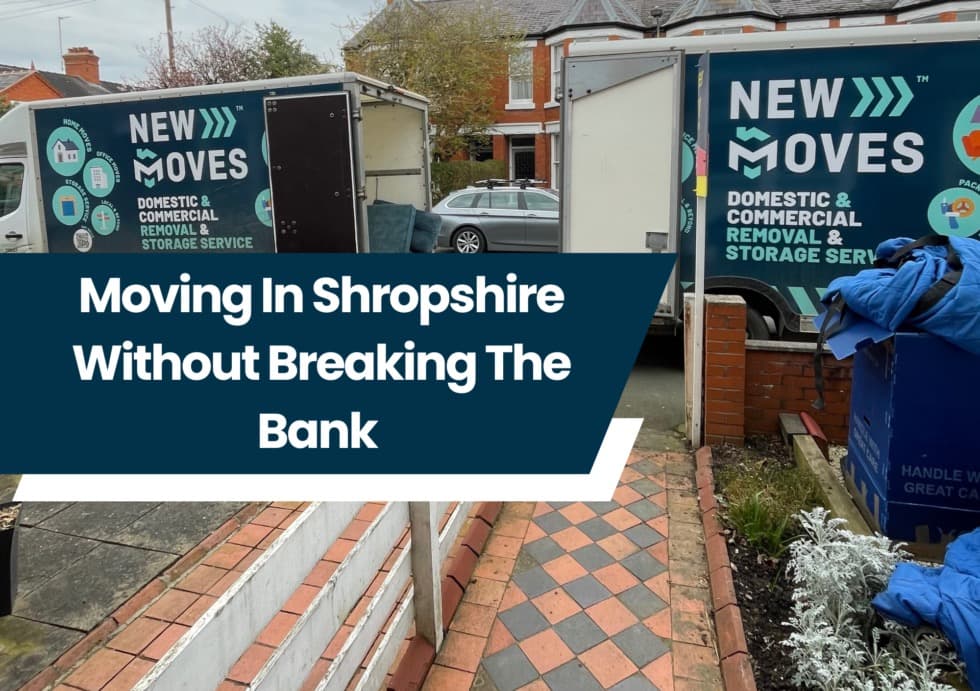 New Moves branded removal vans parked outside a house with blue storage crates during a move in Shropshire