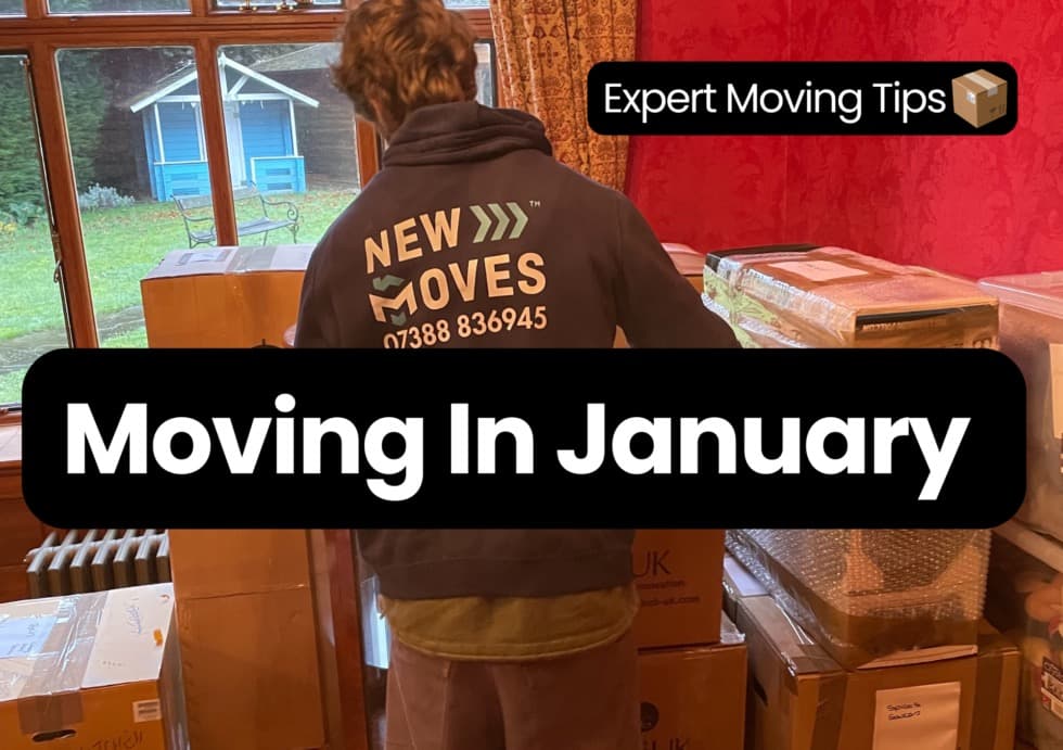 A New Moves team member in a branded hoodie packing boxes for a January move