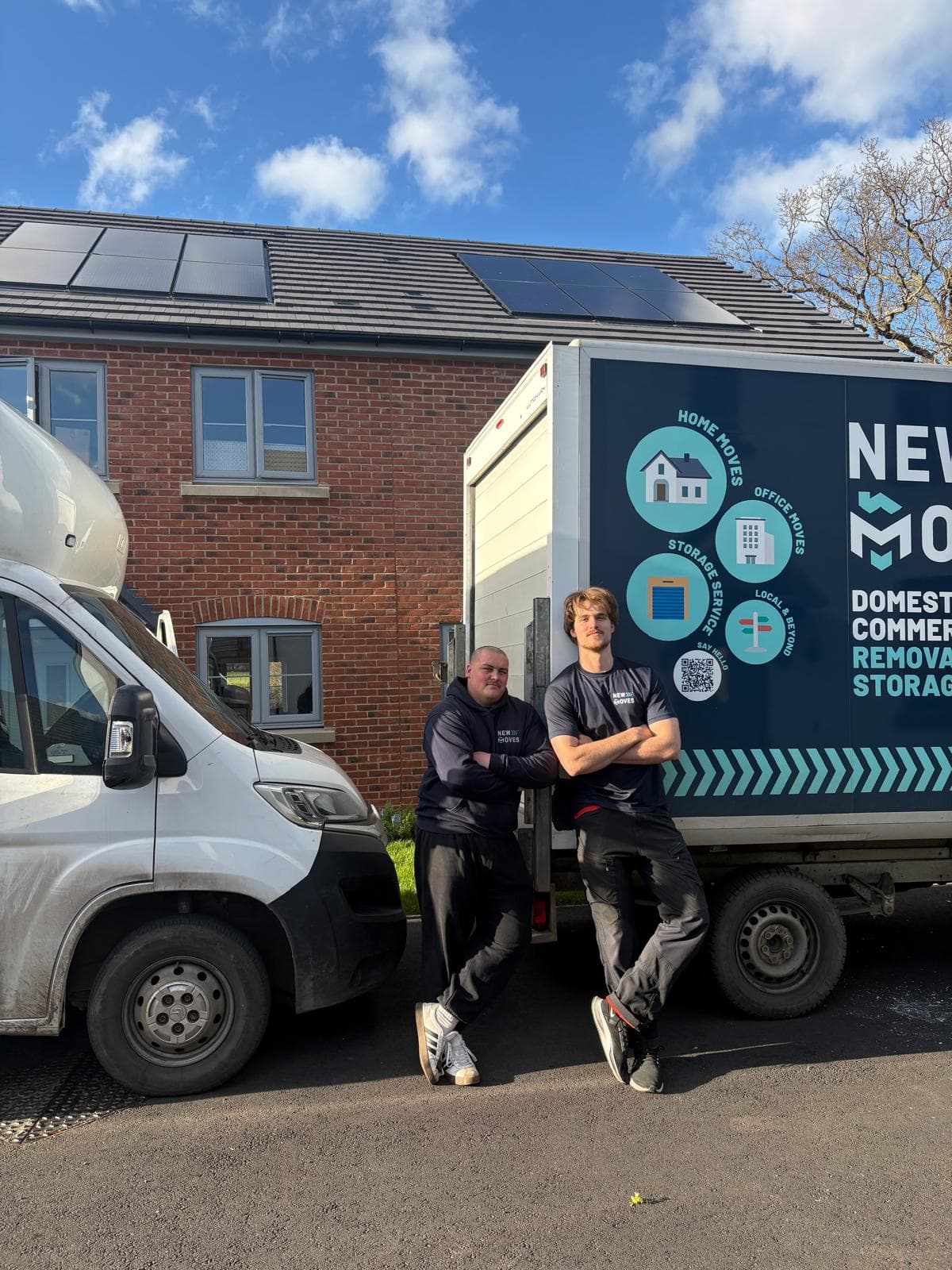 A New Moves Removals team member standing on a narrow residential street